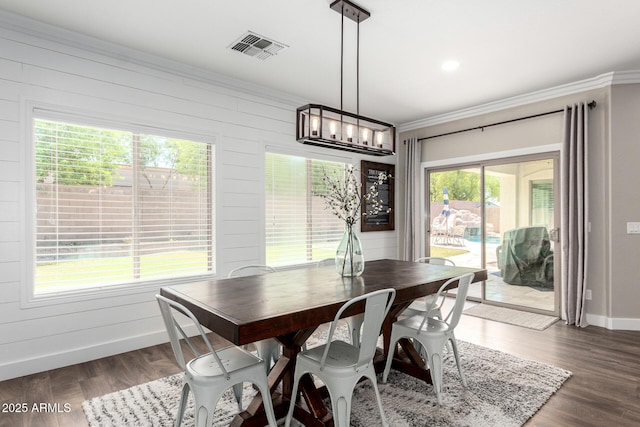 6317 S Banning St, Gilbert, AZ 85298 - dining area with crown molding, dark wood-type flooring, a chandelier, and wooden walls