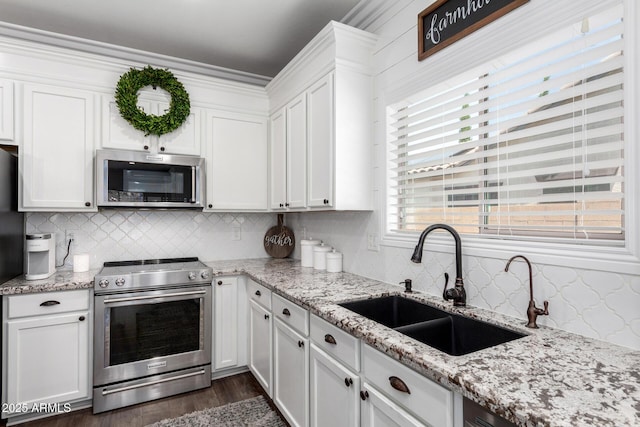 6317 S Banning St, Gilbert, AZ 85298 - kitchen with stainless steel appliances, white cabinetry, and tasteful backsplash