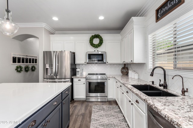 6317 S Banning St, Gilbert, AZ 85298 - kitchen featuring stainless steel appliances, white cabinets, backsplash, ornamental molding, and dark wood-style floors
