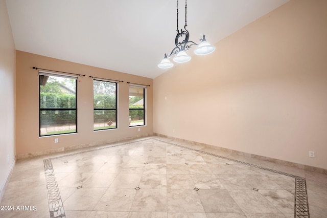 unfurnished room with a chandelier and vaulted ceiling