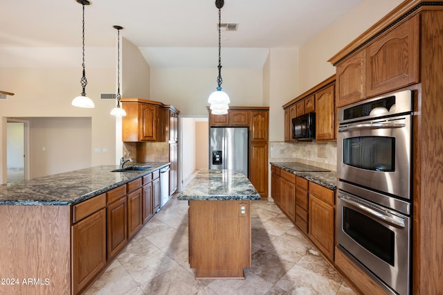 kitchen with kitchen peninsula, black appliances, dark stone counters, and pendant lighting