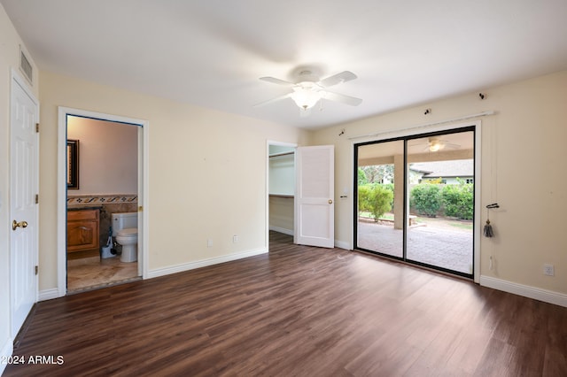 unfurnished bedroom featuring access to exterior, a closet, ensuite bath, dark hardwood / wood-style flooring, and ceiling fan