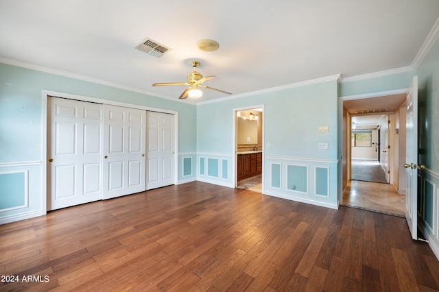 unfurnished bedroom with crown molding, wood-type flooring, and ceiling fan