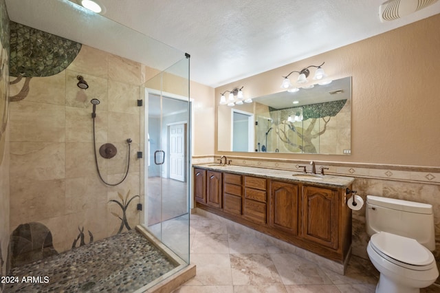 bathroom featuring vanity, a shower with shower door, a textured ceiling, and toilet