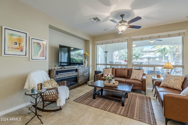 living room featuring light tile patterned floors and ceiling fan