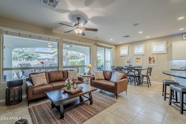 living room with light tile patterned floors and ceiling fan