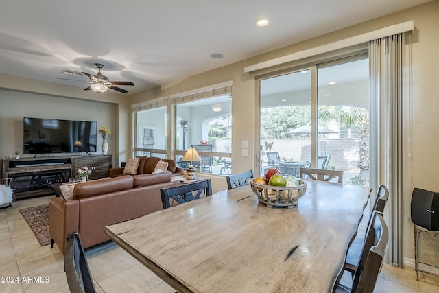 tiled dining area with ceiling fan