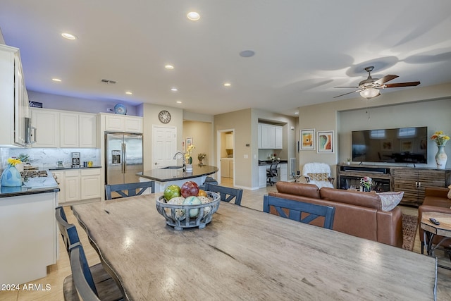 tiled dining room featuring washer and dryer, sink, and ceiling fan