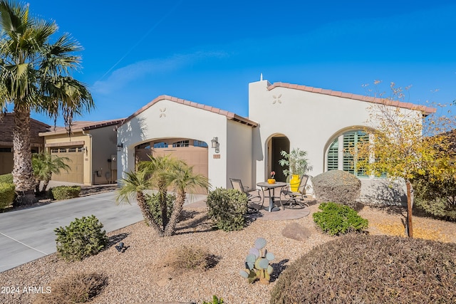 mediterranean / spanish house with a garage