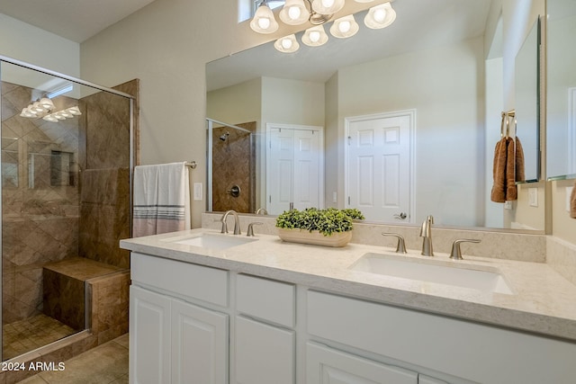 bathroom with vanity, tiled shower, and tile patterned floors