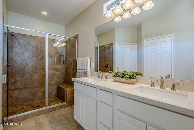 bathroom with vanity, an enclosed shower, tile patterned flooring, and an inviting chandelier