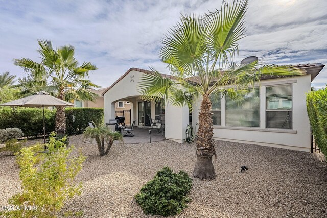 back of house with a patio