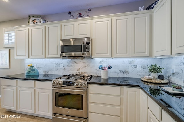 kitchen with white cabinetry, appliances with stainless steel finishes, and light tile patterned flooring