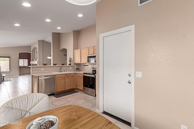 12787 S 175th Ave, Goodyear, AZ 85338 - kitchen with light tile patterned flooring, arched walkways, light brown cabinetry, a sink, and appliances with stainless steel finishes
