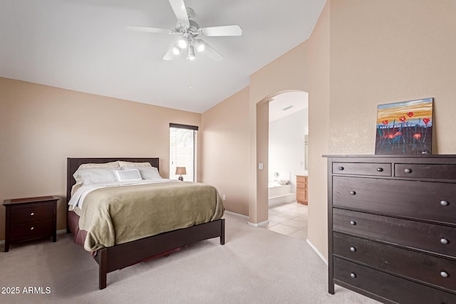 12787 S 175th Ave, Goodyear, AZ 85338 - bedroom with baseboards, ensuite bath, arched walkways, vaulted ceiling, and light colored carpet