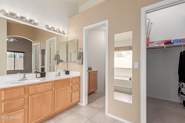 12787 S 175th Ave, Goodyear, AZ 85338 - bathroom with a sink, double vanity, a spacious closet, and tile patterned flooring