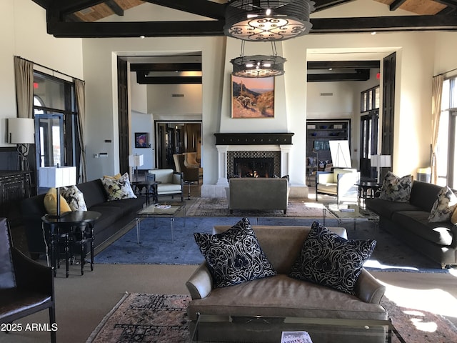 12787 S 175th Ave, Goodyear, AZ 85338 - living room with beamed ceiling, a high ceiling, and a warm lit fireplace