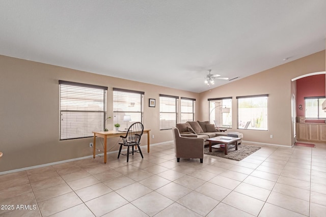 12787 S 175th Ave, Goodyear, AZ 85338 - living room with baseboards, ceiling fan, vaulted ceiling, light tile patterned floors, and arched walkways