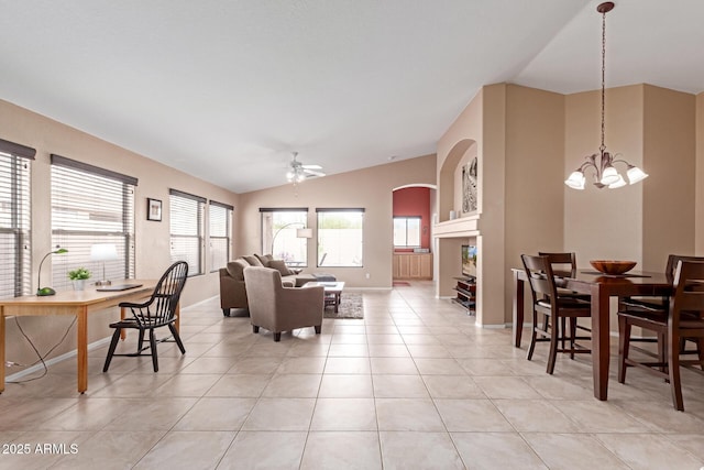 12787 S 175th Ave, Goodyear, AZ 85338 - living room with lofted ceiling, ceiling fan with notable chandelier, arched walkways, light tile patterned floors, and baseboards