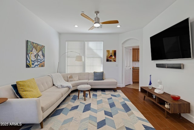 living room featuring a ceiling fan, baseboards, recessed lighting, and wood finished floors