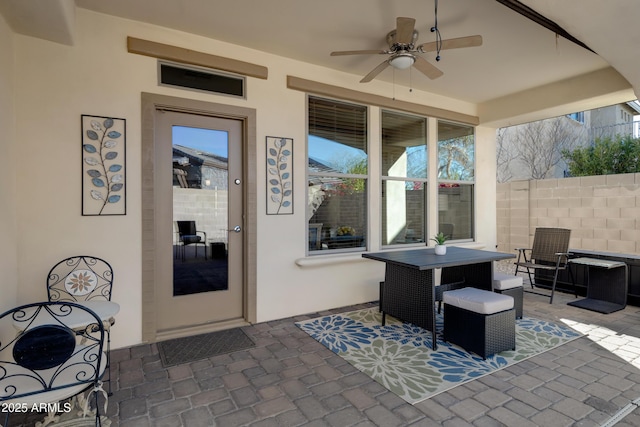 view of patio with fence and a ceiling fan