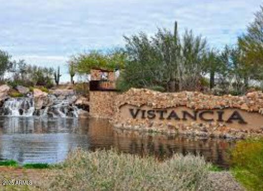 community / neighborhood sign with a water view