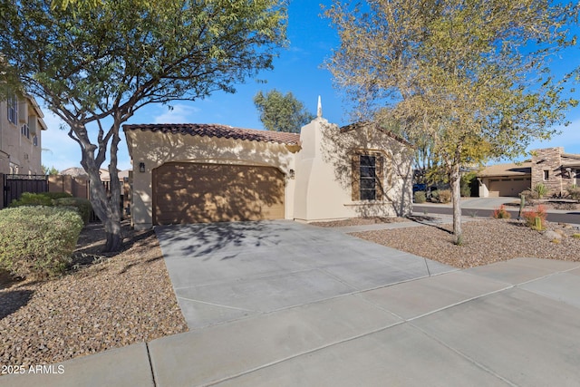 view of front facade featuring driveway, a tiled roof, fence, an attached garage, and stucco siding