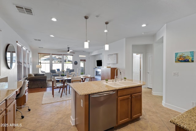 kitchen with a sink, stainless steel dishwasher, light tile patterned floors, and visible vents