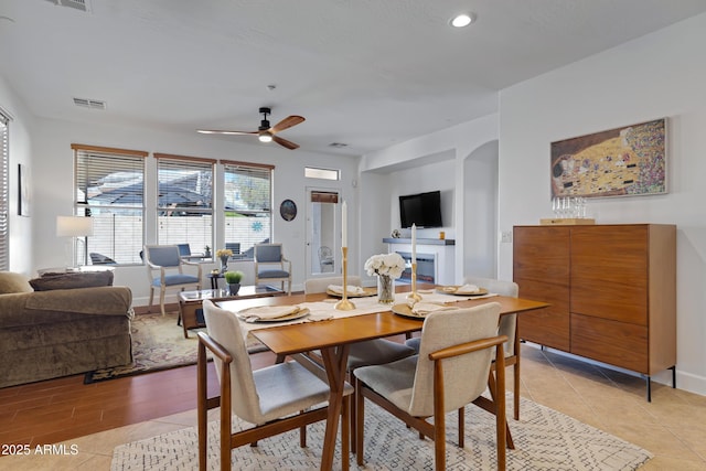 dining space with light tile patterned floors, a ceiling fan, visible vents, baseboards, and recessed lighting