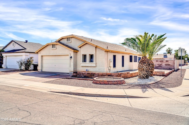 view of front of property with a garage, concrete driveway, and stucco siding