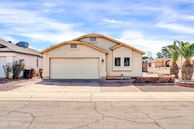 view of front of property featuring a garage, driveway, and stucco siding