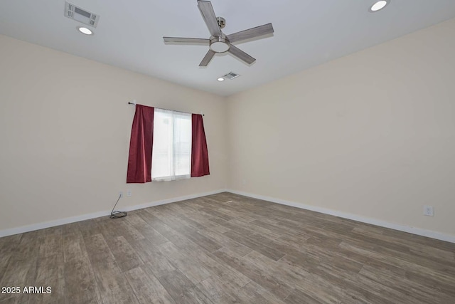 unfurnished room with ceiling fan and hardwood / wood-style flooring