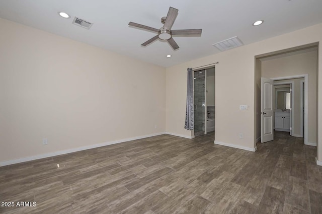 spare room with ceiling fan and dark hardwood / wood-style floors