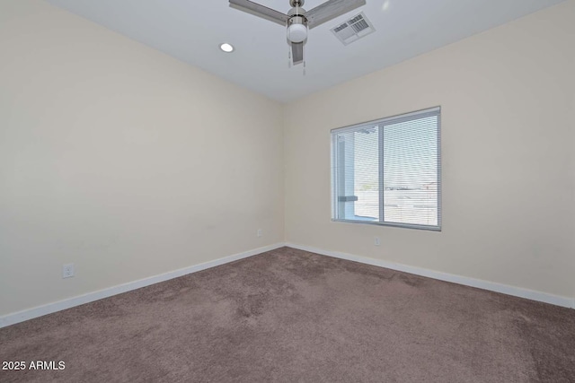 spare room featuring ceiling fan and carpet floors