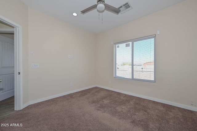 spare room with carpet floors and ceiling fan