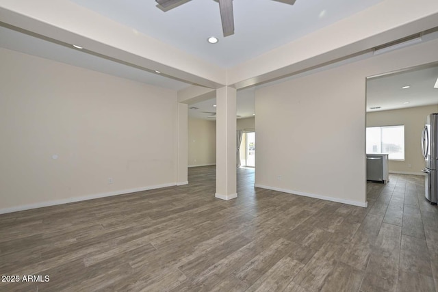 spare room featuring ceiling fan and dark hardwood / wood-style flooring