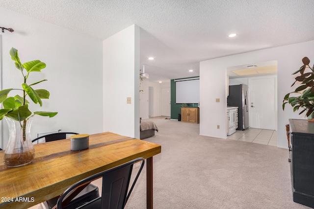 interior space featuring light carpet and a textured ceiling