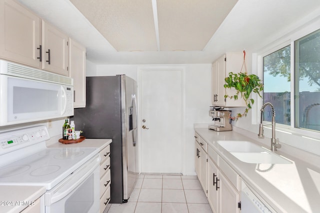 kitchen featuring white cabinets, sink, and white appliances