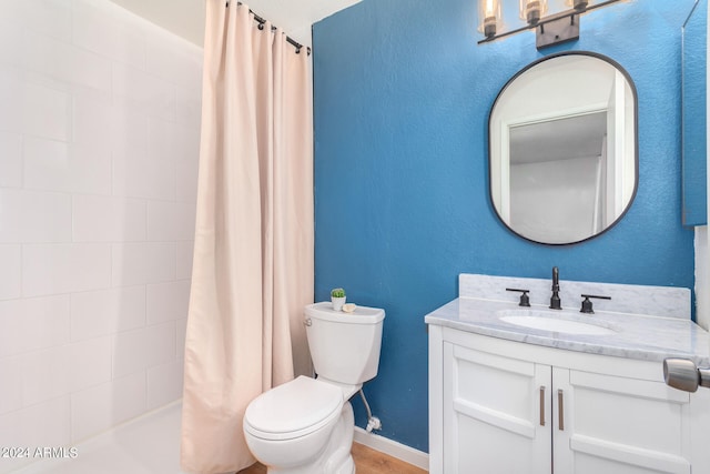 bathroom with vanity, toilet, and walk in shower