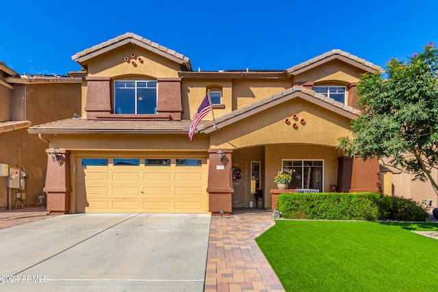 view of front of house with a front yard and a garage