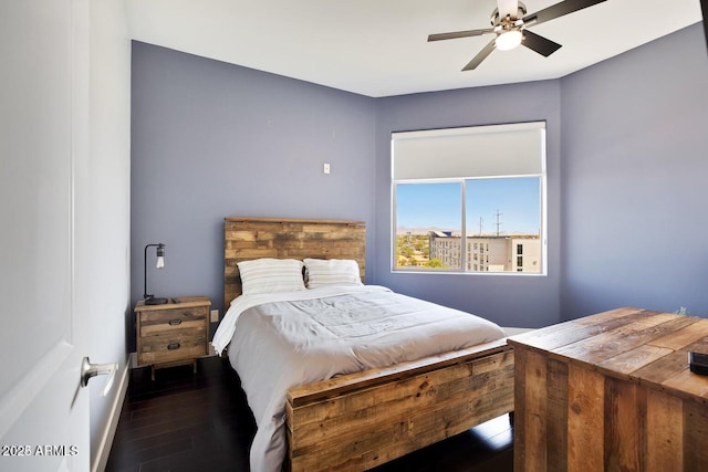 bedroom with a ceiling fan, baseboards, and wood finished floors