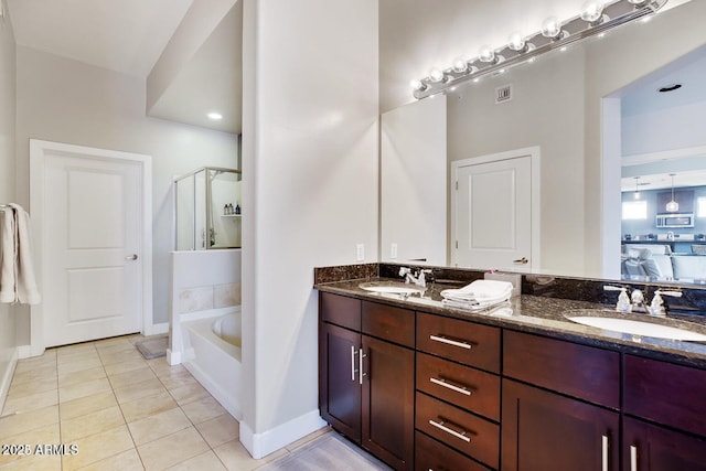 bathroom with tile patterned flooring, double vanity, visible vents, and a sink