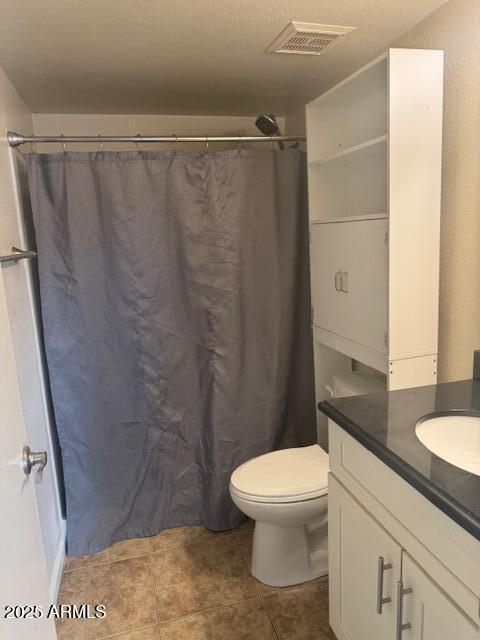 bathroom featuring vanity, a shower with curtain, tile patterned floors, and toilet