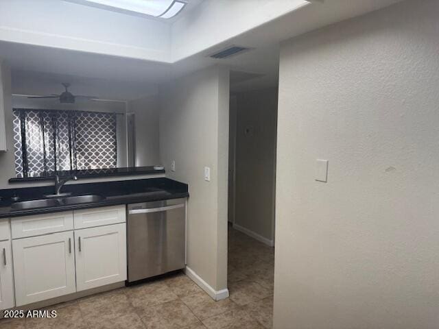 kitchen featuring sink, light tile patterned floors, ceiling fan, white cabinetry, and stainless steel dishwasher