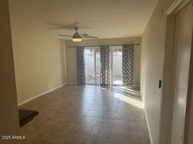 tiled empty room with ceiling fan