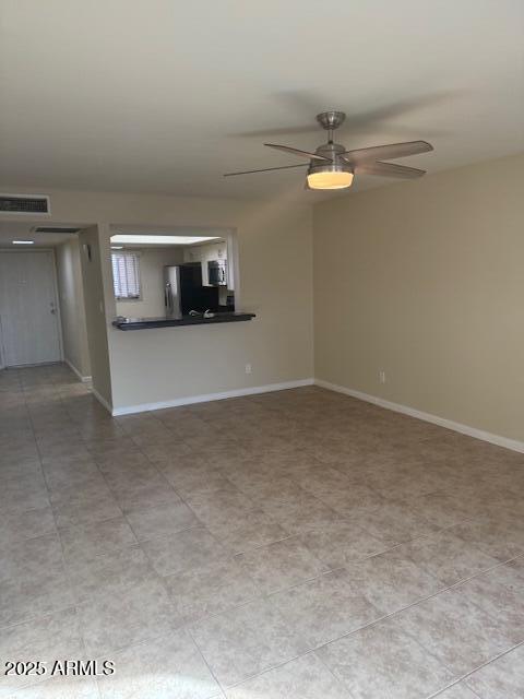 unfurnished living room featuring ceiling fan