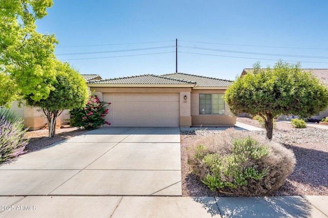 2721 N 107th Dr, Avondale, AZ 85392 - view of front facade with a tile roof, an attached garage, stucco siding, and concrete driveway
