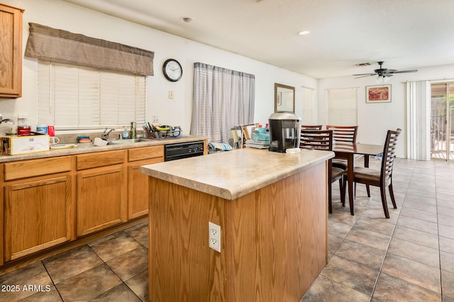 2721 N 107th Dr, Avondale, AZ 85392 - kitchen with a center island, light countertops, ceiling fan, black dishwasher, and tile patterned floors