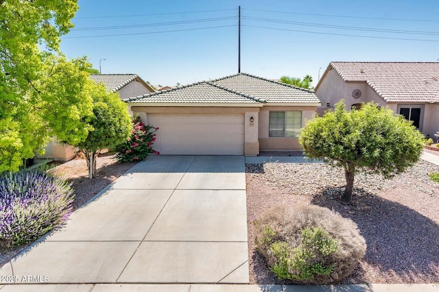 2721 N 107th Dr, Avondale, AZ 85392 - view of front of house featuring stucco siding, driveway, an attached garage, and a tile roof
