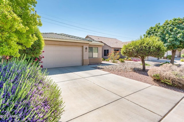 2721 N 107th Dr, Avondale, AZ 85392 - view of front of property with a tile roof, a garage, concrete driveway, and stucco siding